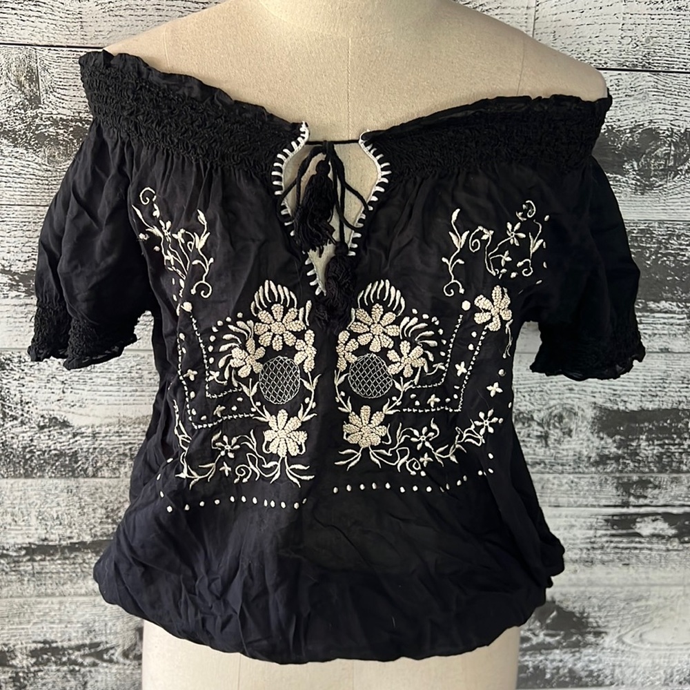 Joie black ethnic blouse with smocked hem and smocked edge of sleeves.